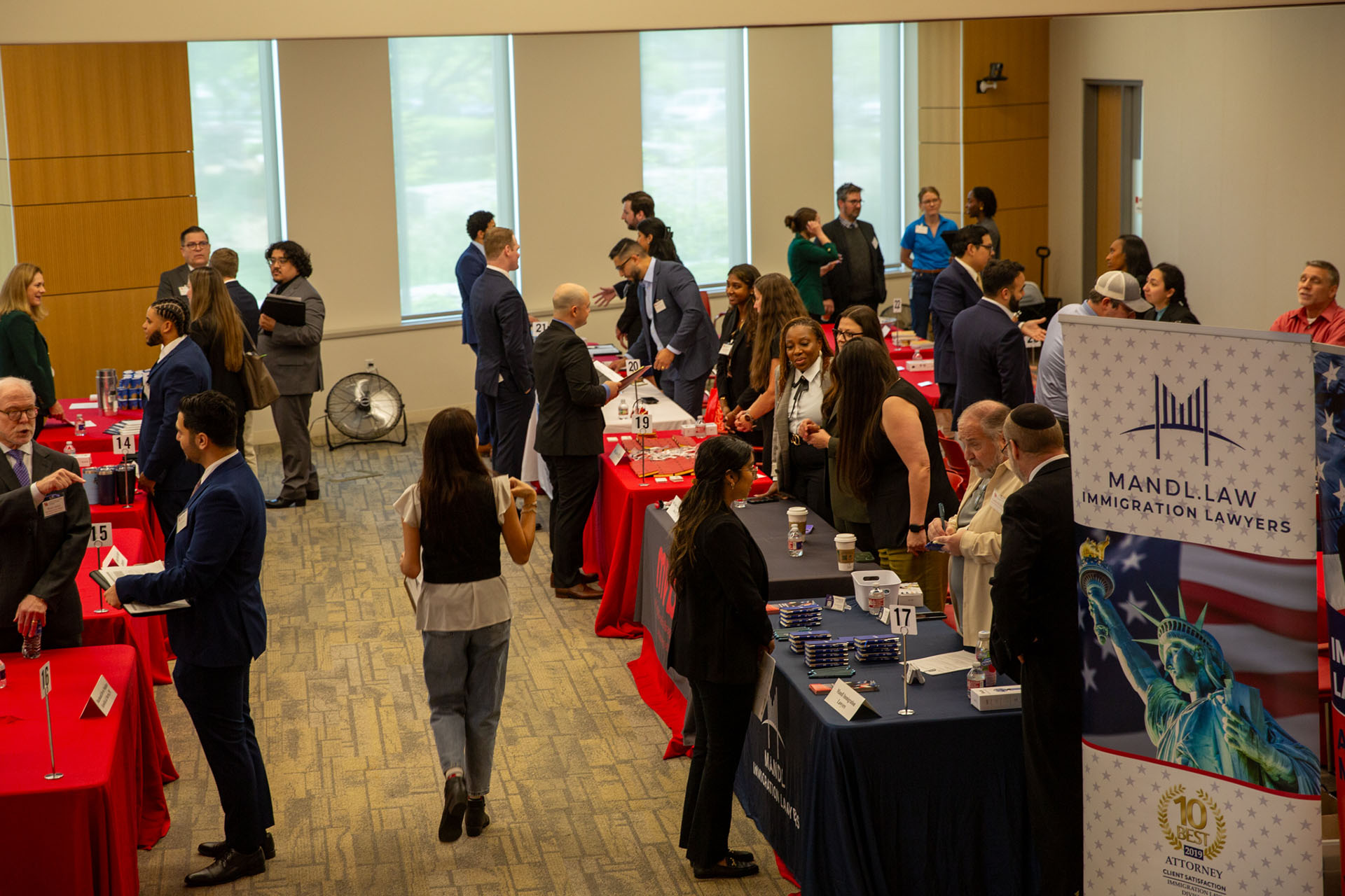 A wide view of employers and law students networking across multiple recruiting tables during the open house at the University of Houston Law Center.